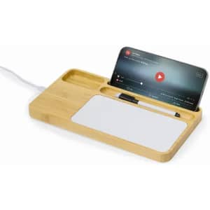 A bamboo docking station featuring a phone holder, a pen, and a white surface for notes. Includes a charging cable.