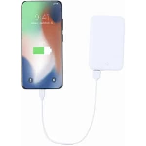 A smartphone with a partially charged battery connected to a white portable power bank via a charging cable.