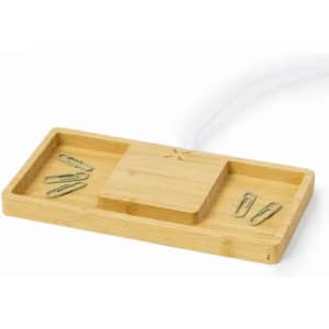 A bamboo desk organiser with compartments for paper clips and a central section. Features a natural wood finish.