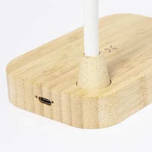 A bamboo phone holder with a white stem and a USB-C port on the base, featuring a natural wood finish.