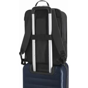A black backpack with adjustable straps is positioned on top of a blue suitcase, featuring a pulling handle.