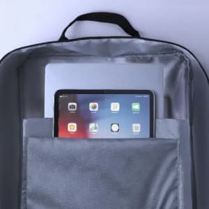 A backpack interior featuring a laptop and tablet in grey compartments, with a black handle visible at the top.