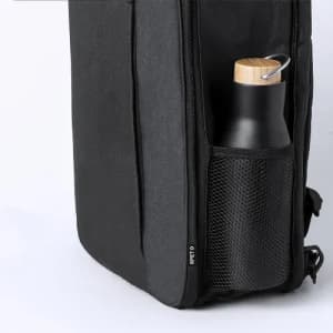 A black drink bottle with a wooden top is partially visible in a side mesh pocket of a black bag.