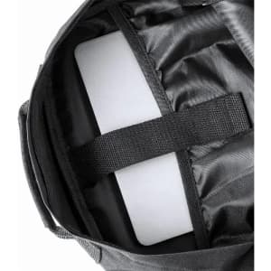 A bag interior featuring a black lining and a padded section for a laptop or device, secured with a strap.