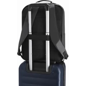 A black backpack with adjustable straps, fitted securely on the handle of a blue suitcase. The backpack features a subtle logo.