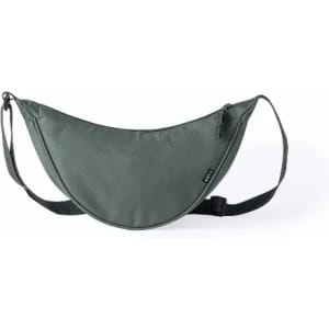 A sling bag in a muted grey colour with a curved design, featuring a strap and zippered pockets.