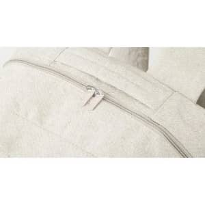 A backpack in a light cream colour featuring a zippered compartment and adjustable straps. It has a branding logo.