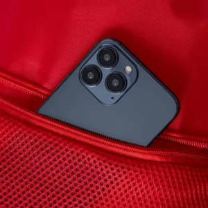 A smartphone with a blue case partially visible in a red mesh pocket.
