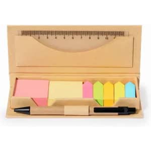 A stationary set in a natural wooden holder with a ruler, pastel sticky notes, and a black pen.
