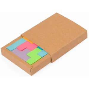 A box containing colourful puzzle pieces in various shapes, including pink, green, blue, and yellow. The box is brown.