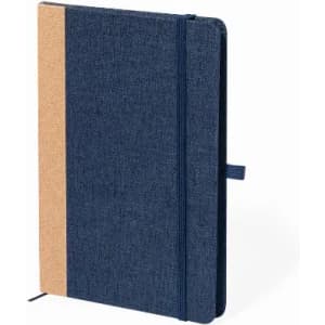 A notebook with a dark blue fabric cover and a cork accent, featuring a ribbon bookmark and an elastic closure.