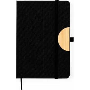 A black notebook with a bamboo accent, featuring an elastic band closure and a textured surface.
