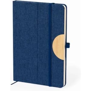 A navy blue notebook with a fabric cover and a bamboo accent, featuring an elastic band closure.