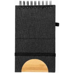 A notebook with a fabric cover in black, featuring a wooden base and spiral binding.