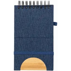 A notebook with a navy blue fabric cover, spiral binding, and a wooden base for support.