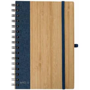 A spiral-bound notebook with a bamboo cover and a blue fabric section, featuring an elastic band closure.