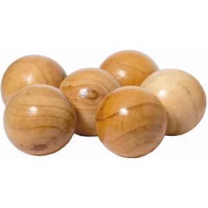 A set of six polished wooden balls in varying shades of light brown and cream, stacked closely together.