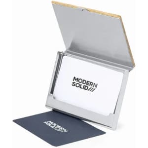 A business card holder with a metal finish and a wooden back, displaying business cards inside.