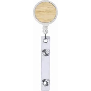 A badge holder with a circular wooden top and a silver metal clip below, featuring two snap buttons.