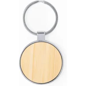 A keychain featuring a circular wooden insert with a metallic ring. The wood has a light, natural finish.