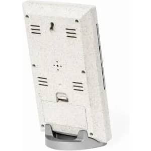 A white and grey device with a textured back, featuring slots and a stand for support.