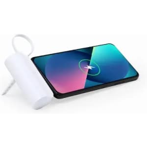 A drink bottle in white next to a smartphone with a vibrant screen displaying blue and green colours.