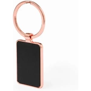 A keyring featuring a rectangular black tag with a shiny rose gold metal frame and ring.