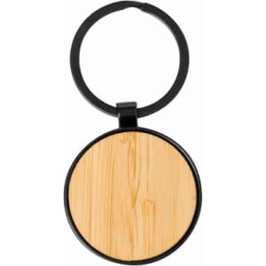 A keychain with a round black metal frame and a light wooden centre. It features a logo on the frame.