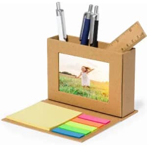 A desk organiser with a photo frame, holding pens, a ruler, and sticky notes in various bright colours.