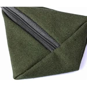 A green canvas pouch with a grey zipper, featuring a triangular shape and textured fabric.