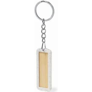 A keyring featuring a rectangular design with a wooden centre and a metallic chain. The outer frame is concrete grey.