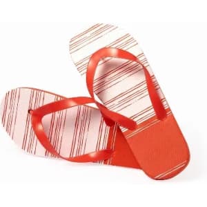 A pair of flip-flops in red with a striped pattern featuring shades of red and cream. They have a branded logo.