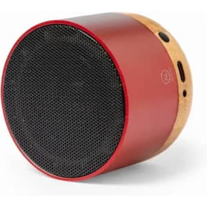 A portable speaker in red and gold, featuring a black mesh grille, with buttons and a charging port on the side.