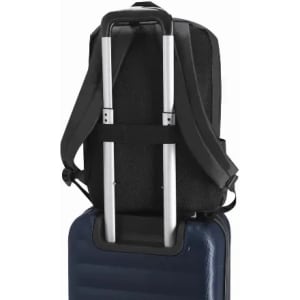A black backpack with adjustable straps resting on a blue suitcase. The backpack features a handle pass-through.