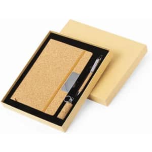 A gift set featuring a cork notebook, a pen, and packaging in gold. The notebook has an elastic band.