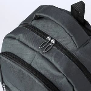 A close-up of a dark grey backpack featuring two zippered compartments and a sturdy handle.