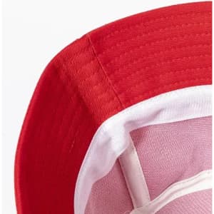 A red hat with a white inner lining and structured brim, featuring stitching detail and a logo inside.