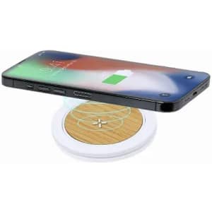 A wireless charger with a wooden surface and white base, with a smartphone placed above, showing charging status.