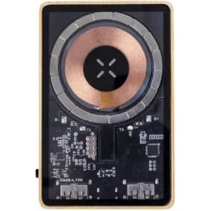 A wireless charger with a gold and black design, featuring a central coil and various electronic components.