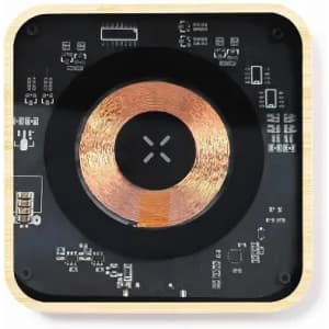 A wireless charger with a wooden frame, featuring a circular copper coil and a black surface with circuit patterns.