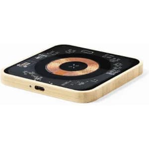 A wireless charging pad with a black surface and a wooden base, featuring a compact, square design and a logo.