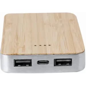A portable power bank with a bamboo finish and metal edges, featuring two USB ports and a USB-C port.