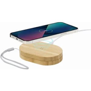 A charging pad with a wooden finish, featuring a smartphone magnetically aligned above it.