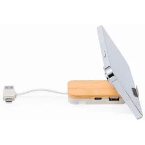 A wireless charging station with a bamboo base and a silver charging pad, featuring USB and USB-C ports.