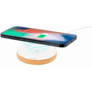 A wireless charger with a round base in a light colour, supporting a smartphone that displays a charging icon.