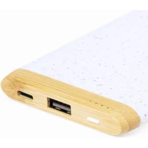 A phone charger with a white speckled body and a wooden accent on the edges, featuring USB and Type-C ports.