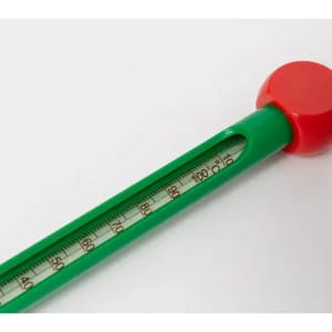 A green thermometer with a red cap features a thermometer scale marked in degrees.