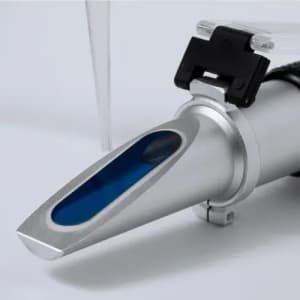 A drink bottle with a silver body and a blue section around the spout, featuring a black clasp and clear straw.