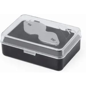 A black storage box with a transparent lid containing two optical lenses labelled "10X" and "20X".