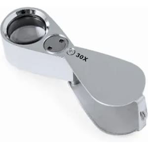 A magnifying glass with a chrome finish, featuring a 30X magnification lens and a foldable design.